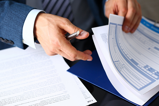 a male doctor reviewing paper forms